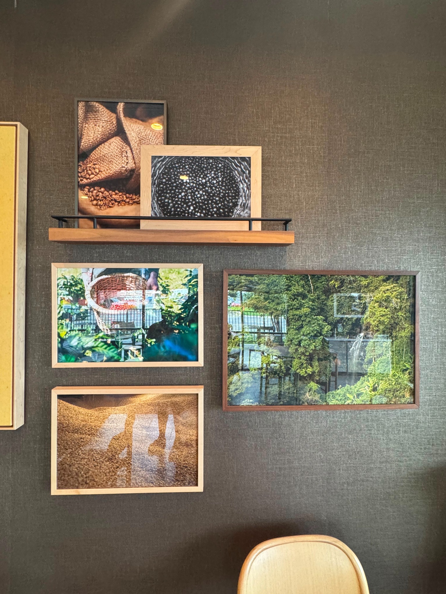 Framed photographs of coffee beans and black beans on an earthy textured wall